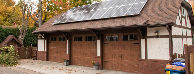 three car detached garage with solar panels on the roof