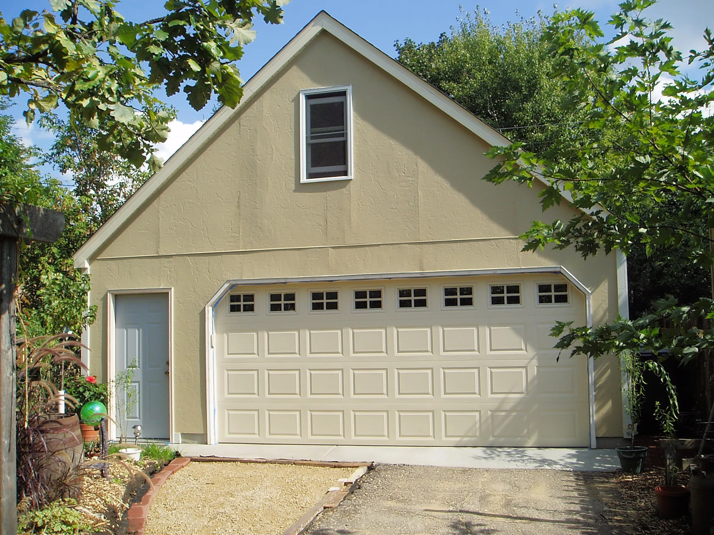 Tall detached garage with loft storage, two-car door, side entry and upper window