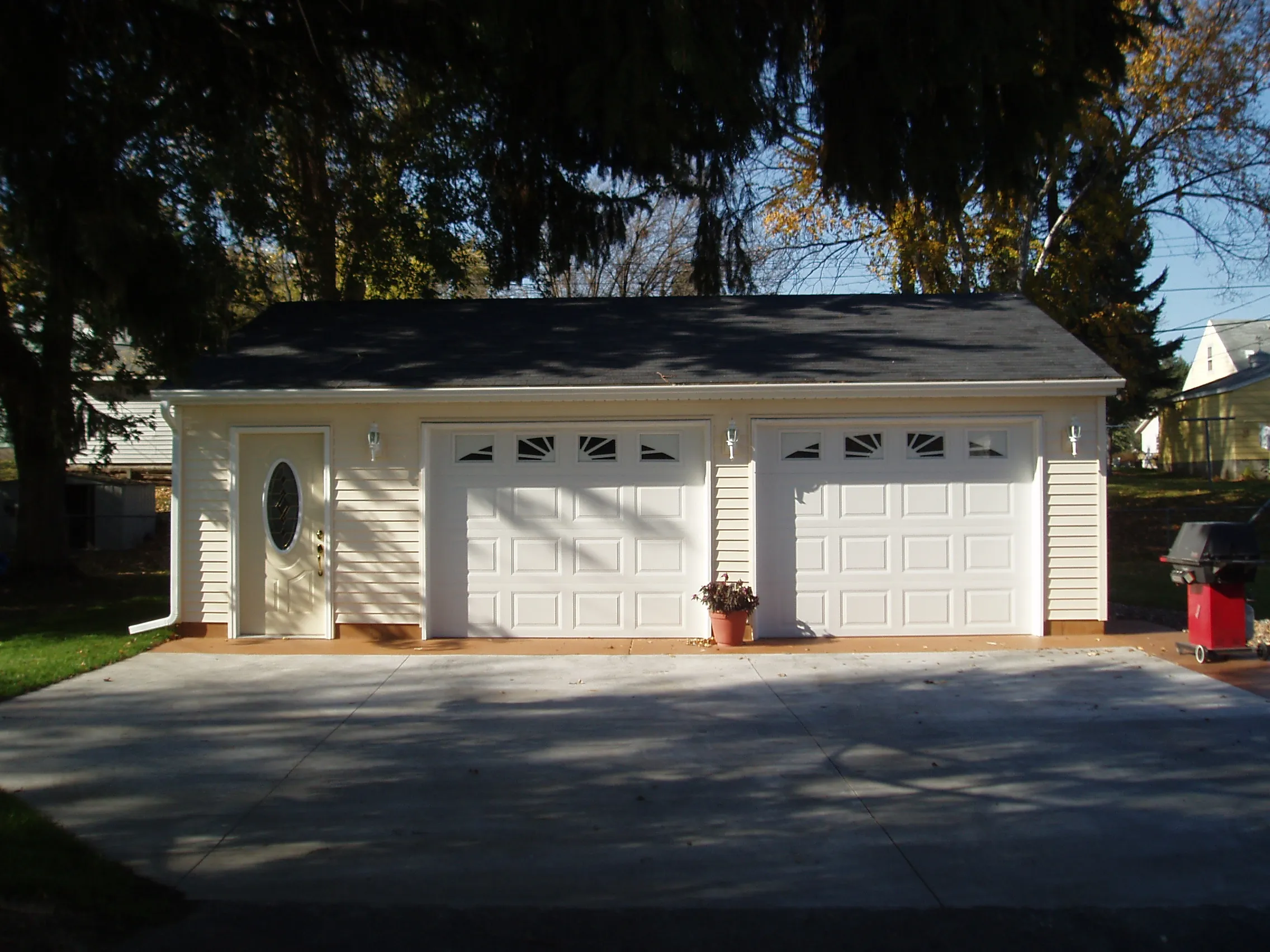 two-car detached garage with separate overhead doors, side entry and beige siding
